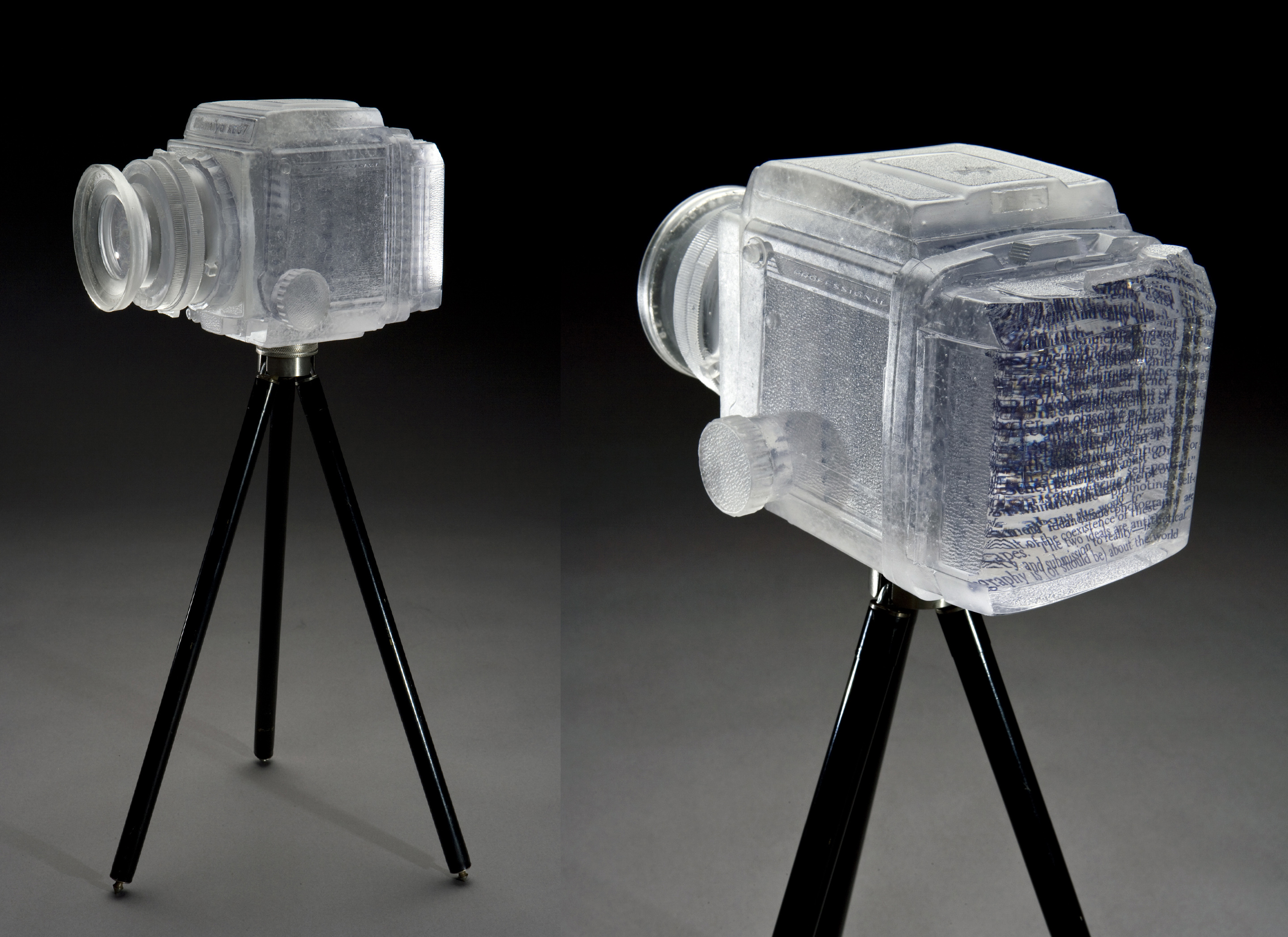 Title: "1,000 Words" Date: 2012 Size: 6.25"h x 9.5"w x 11"d Medium: Glass, ceramic decal, oil paint, antique tripod Technique: Lost wax casting, inlaid ceramic decal layers, painted, polished Photo: John Mueller Photography Exactly 1,000 words taken from Susan Sontag’s book "On Photography" are layered inside this cast glass camera.