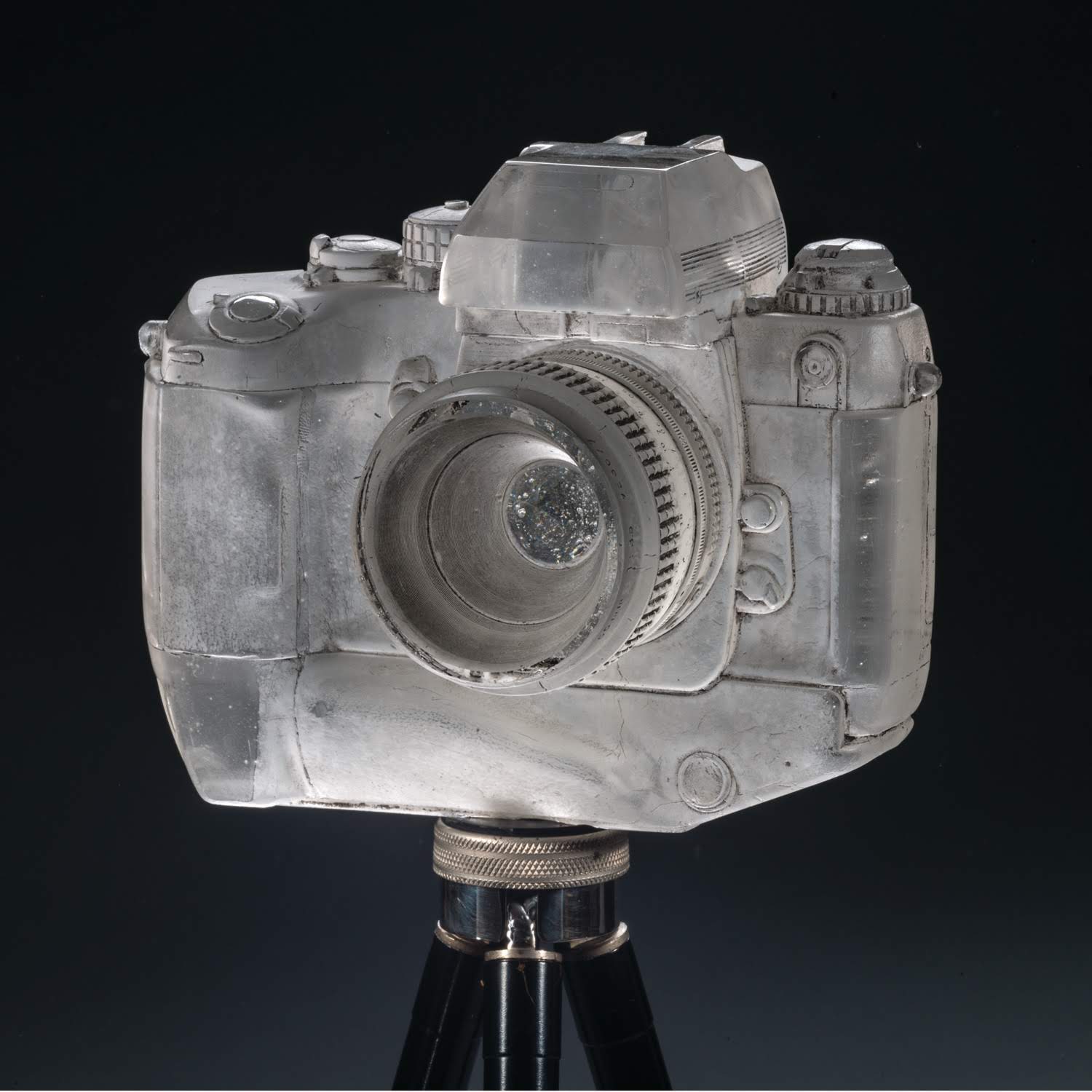 TITLE: Poetry of Light MEDIUM: Glass, paint, antique tripod METHOD: Cast glass, acid etched, painted, polished SIZE: 22"h x 10"w x 10" (on tripod) DATE: 2016 PHOTO: Benjamin Corda